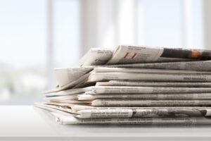 Pile of printed newspapers, close-up view