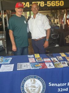 Senator Stefano stands behind his office’s booth at the Fayette County Fair with Fayette County Farm Bureau president Darrell Becker.